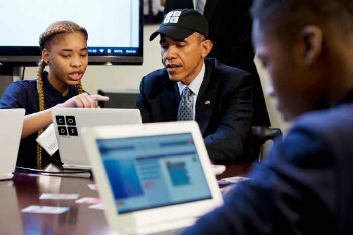 President Obama learns to write code alongside student Adrianna Michell in Newark, NJ.