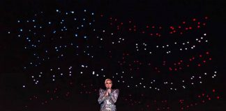 Intel drones form the United States flag behind Lady Gaga at the Super Bowl half-time show.