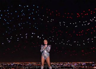 Intel drones form the United States flag behind Lady Gaga at the Super Bowl half-time show.