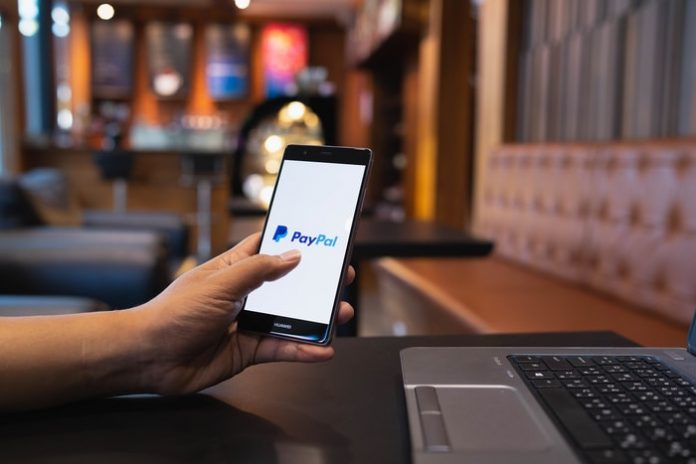 Man Using PayPal on Smartphone
